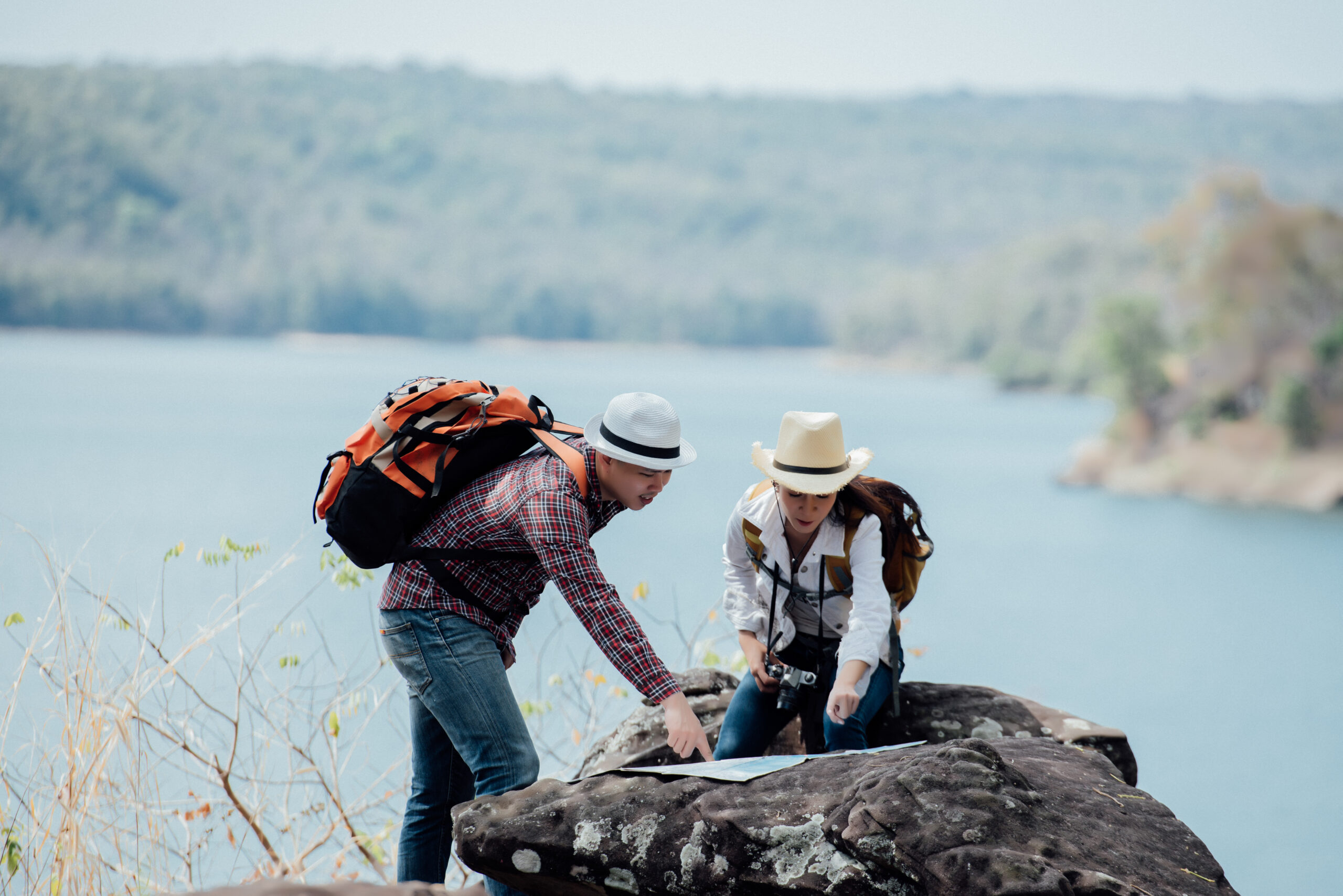 Couple family traveling together,Tourist couple Backpack along mountains and coast, freedom and active lifestyle concept